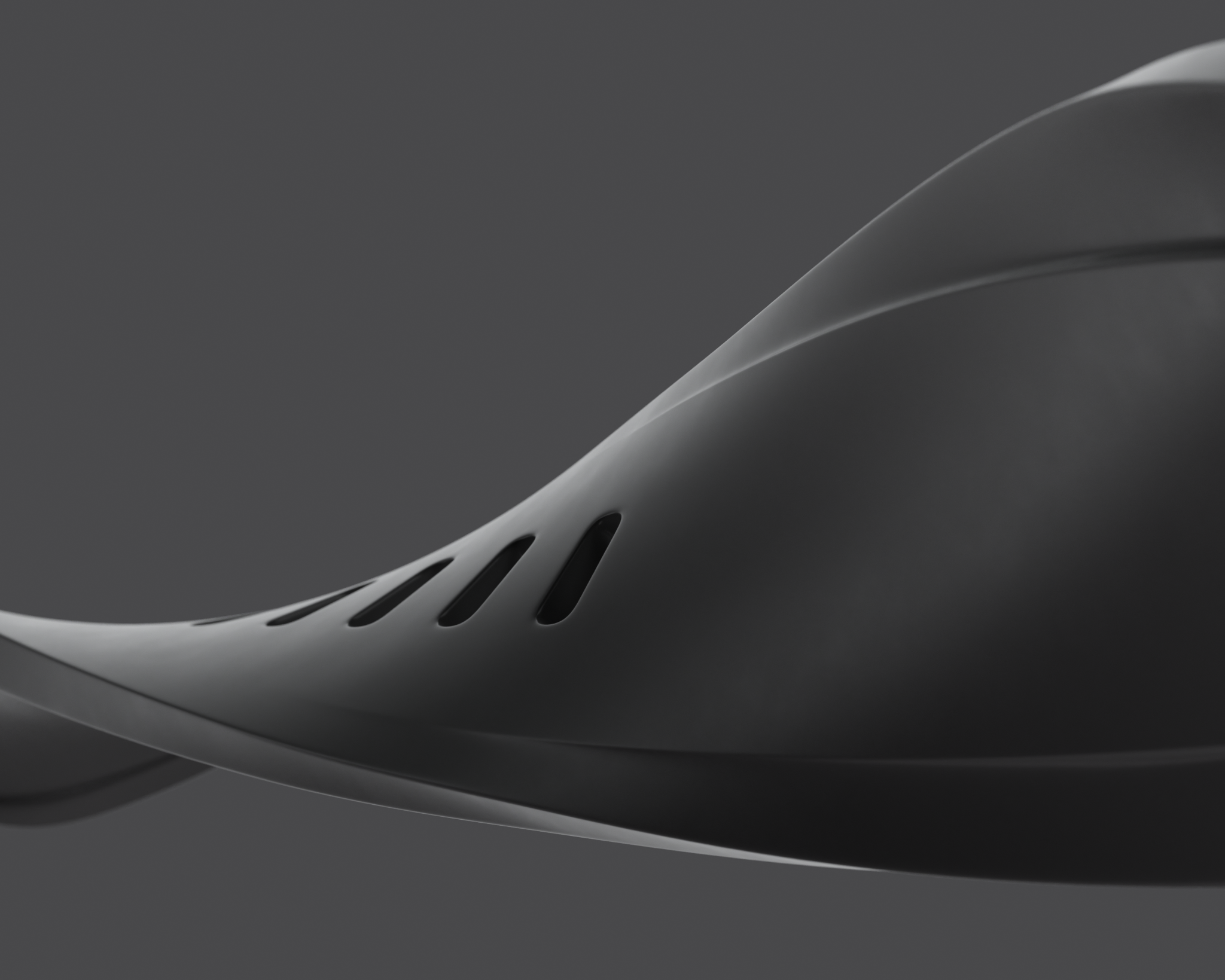 Black, wavy watch strap on a dark gray background